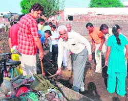 Deputy commissioner B.S. Malik takes part in an anti-polythene drive at a village in Karnal. 