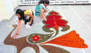 Girls participate in a rangoli competition on the eve of Diwali at JDs Fashion Institute in Jammu. 
