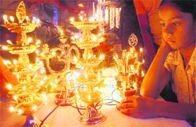 A child is bedazzled by the colourful lights in a shop on the eve of Diwali in Jalandhar