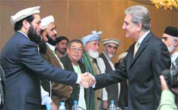 Pakistani foreign minister Shah Mahmood Qureshi (right) meets Afghan tribal elders during the opening session of a Tribal Elders Jirga meeting in Islamabad