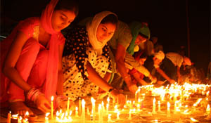 Women light candles to celebrate Diwali at the Qila Mubarak in Bathinda on Tuesday evening.