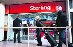 A passenger reads a notice outside the closed office of the Danish-based Sterling Airways  at Copenhagen Airport. 