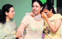 Wailing family members of co-pilot Manjit Singh (inset), who was killed in an air crash near Ludhiana, in Panchkula
