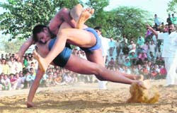 Contestants in action during a wrestling competition organised on the occasion of Govardhan Puja in Faridabad