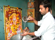 A man worships Lord Vishwakarma in Amritsar on Wednesday.