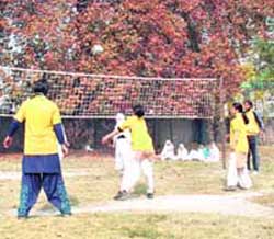 Girls in action during the inter-college volleyball final match organised by University of Kashmir in Srinagar on Wednesday. 