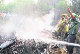 Firemen try to douse flames.