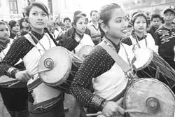Nepalese girls beat on traditional drums during a rally to mark the New Year of Nepal Sambat in Kathmandu on Wednesday. According to the ethnic calendar of Nepal Sambat, Wednesday is the beginning of the year 1129. 