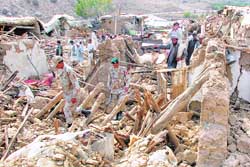 Pakistani soldiers inspect collapsed houses in Ziarat, about 50 km north of Quetta, on Wednesday. 