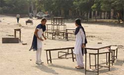 Students clear the Diwali mess in a school
