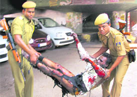 Security personnel carry a body after a bomb blast near Ganeshguri flyover