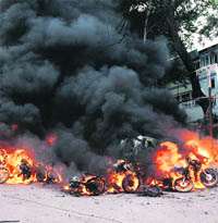 Vehicles blaze after powerful bombs exploded near the District Courts in Guwahati on Thursday.