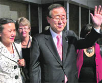 UN Secretary-General Ban ki-Moon, along with his wife Yoo Soon Taek, waves to photographers on their arrival at IGI Airport in New Delhi on Thursday.