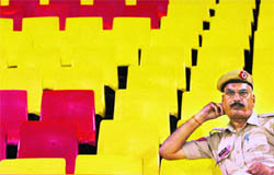 A cop at the empty stands at Tau Devi Lal Stadium during the first match of the ICL season 2 in Panchkula on Friday.