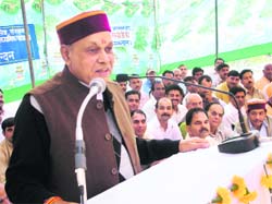 Chief Minister Prem Kumar Dhumal addressing a public gathering in the Fatehpur area of the district on Friday.