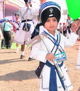 A Nihang prepares his horse for Guru Gobind Singh Khalsa Sports Festival at Hazur Sahib on Friday; (right) a budding gatka player.