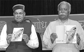 Himachal Pradesh Chief Minister P.K. Dhumal and RSS general secretary Mohan Bhagat release a book in Chandigarh