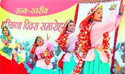 Girls present a folk dance during the Haryana Day celebrations at Raj Bhawan in Chandigarh