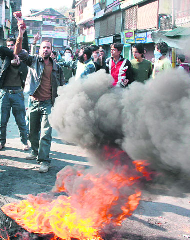 Demonstrators burn tyres in protest against the arrest of JKLF chief Yaseen Malik in Srinagar on Saturday.
