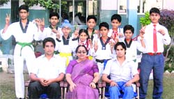 Students of BCM Arya Model Senior Secondary School pose with their teachers after winning four gold medals in Punjab School Games in Taekwondo
