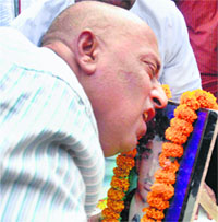 Kundan Prasad Singh weeps next to the photo of his son Rahul Raj during a 'shradhanjali sabha' in Patna on Saturday.