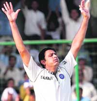 Anil Kumble celebrates the wicket of Brett Lee. Bowling with a bandaged hand, he showed that he was a champion bowler claiming three wickets to hasten Aussie collapse. 