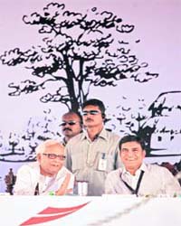 West Bengal Chief Minister Buddhadeb Bhattacharjee (L) and industrialist Sajjan Jindal smile at the foundation stone laying of a 10 million tonne steel plant