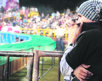 A security man from Maharashtra trying to fight cold during the ICL Tournament at Panchkula on Sunday.