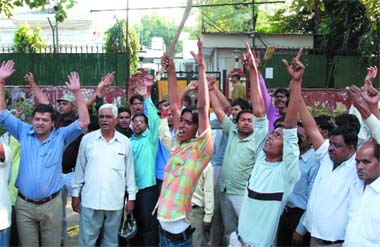 Ticket seekers and their supporters protest outside BJPs chief ministerial candidate V. K.Malhotra's residence against the criterion of selection of candidates for the assembly poll in New Delhi on Sunday. 