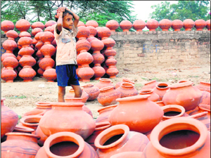 With earthen pots having fallen out of favour, a young seller waits for customers in Karnal on Sunday.