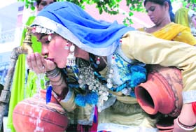 A participant at a cultural function quenches her thirst in Ludhiana