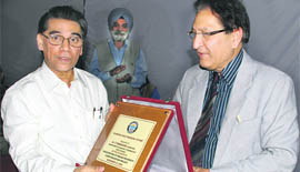 PU vice-chancellor R. C. Sobti presents a memento to T. Ramasami, secretary, department of science and technology, at PU, Chandigarh, on Monday.