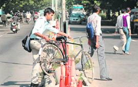 Oblivious of the danger ahead, a cyclist crosses a median