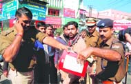 police officials seize Christian literature from members of the Vir Savarkar Sena who planned to burn it at Clock Tower in Dehradun on Monday. 