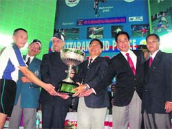 Uttarakhand Governor B.L. Joshi presents the winners trophy to the Nagaland team in Dehradun on Monday.