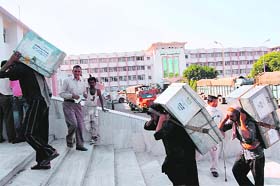 Workers shift official record to the civil secretariat in Jammu on Monday as part of the annual darbar move