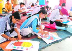 Students participate in a painting contest during the science exhibition at Ramgarhia Girls Senior Secondary School in Ludhiana