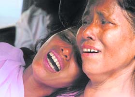 Relatives of Dipak Deka, a victim of last week's bomb blasts, cry during his funeral procession in Guwahati