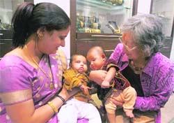 Local guardian of Japanese surrogate baby Manji, Sweta Vijay Vargiya (left), with her baby shares a moment with the Manji and her Japanese grandmother Emiko Yamada before their departure to Tokyo, in New Delhi on Saturday.