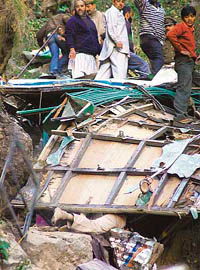 A man lies buried under the wreckage of the bus.