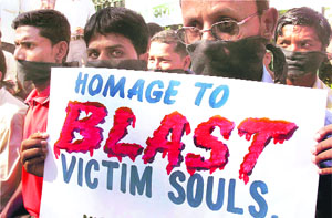 Activists of the All-Assam Unemployed Association demonstrate during a protest rally against serial blasts, in Guwahati on Tuesday.