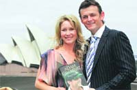 Adam Gilchrist and his wife Mel pose during the launch of his autobiography True Colors in Sydney. 