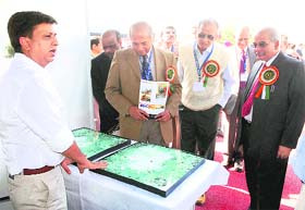The director, Bhabha Atomic Research Centre, Dr S. Banerjee (third from right) along with other delegates examines a blast-proof glass panel at an exhibition organised during a symposium at Ramgarh near Chandigarh