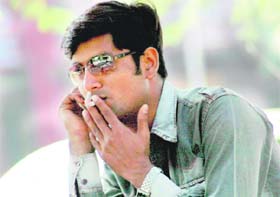 A man enjoys a puff of cigarette at the parking of Sector 17, Chandigarh