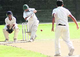 Vivek High Schools batsman slams the ball in their match against GNPS-36 held on St Stephen's School ground in Sector 45