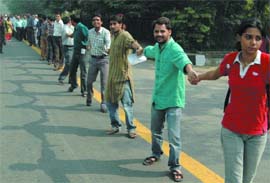 Students of Jamia Millia Islamia form a human chain to promote secularism and communal harmony in New Delhi on Wednesday. 