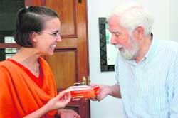 Dr Owen McGowan offers sweets to his granddaughter Shelley Hubele at Dehradun on Wednesday. 