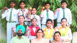 Students, who bagged medals in the CBSE North Zone-II Chess tournament, with principal Baldeep Pandher and coach Karamjit Singh in Ludhiana on Wednesday.