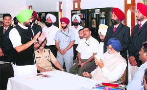 Bholath MLA Sukhpal Singh Khaira apprises Chief Minister Parkash Singh Badal of alleged atrocities committed on Congress workers at Nadala on Wednesday.