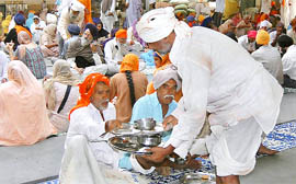 Residents partake of langar during the Gurta Gaddi Diwas celebrations at Nanded.